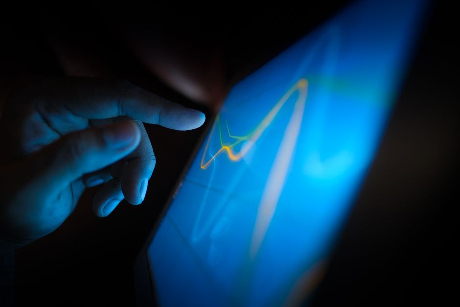 Professional real estate broker in a modern office, analyzing digital data on a futuristic interface, representing AI-powe...